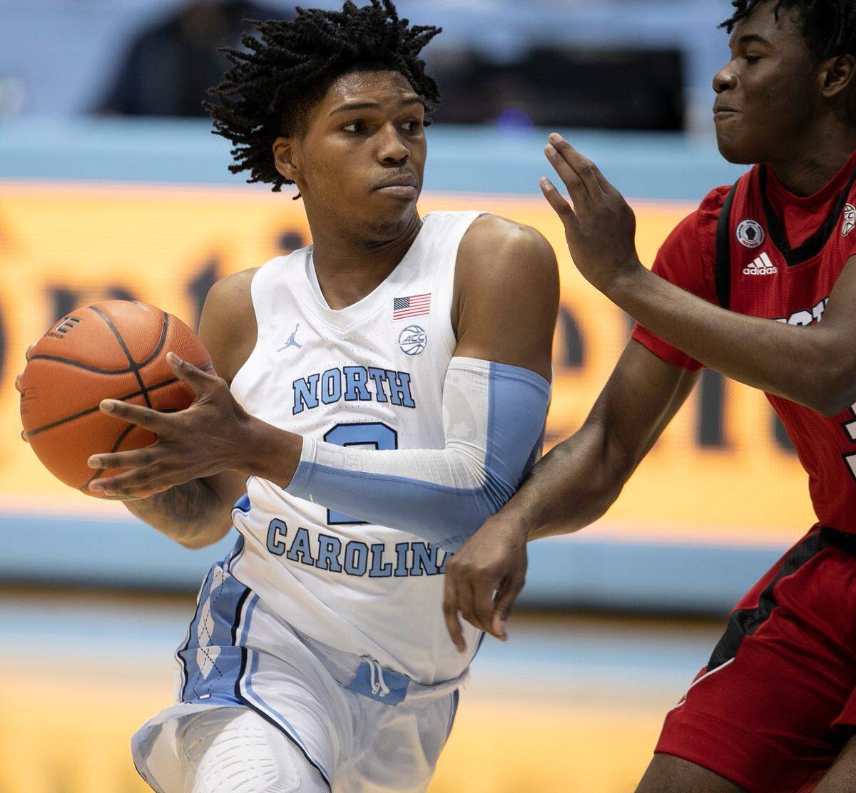 North Carolina’s Caleb Love (2) drives to the basket against N.C. State’s Cam Hayes (3) during the first half on Saturday, January 23, 2021 at the Smith Center in Chapel Hill, NC.