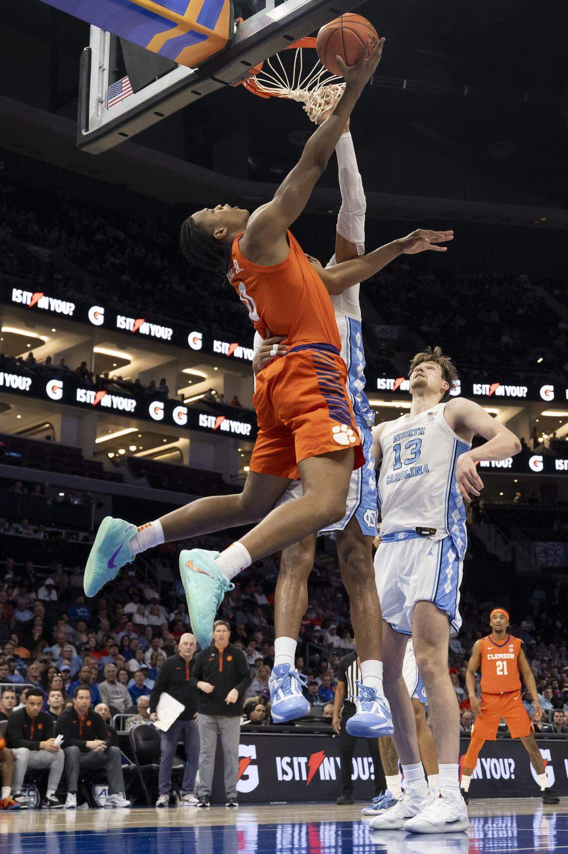 Clemson forward R J Godfrey (0) drives to the basket for a reverse lay-up against North Carolina forward Jarin Stevenson (15) in the first half during the quarterfinals of the ACC Tournament at Spectrum Center in Charlotte, N.C. 