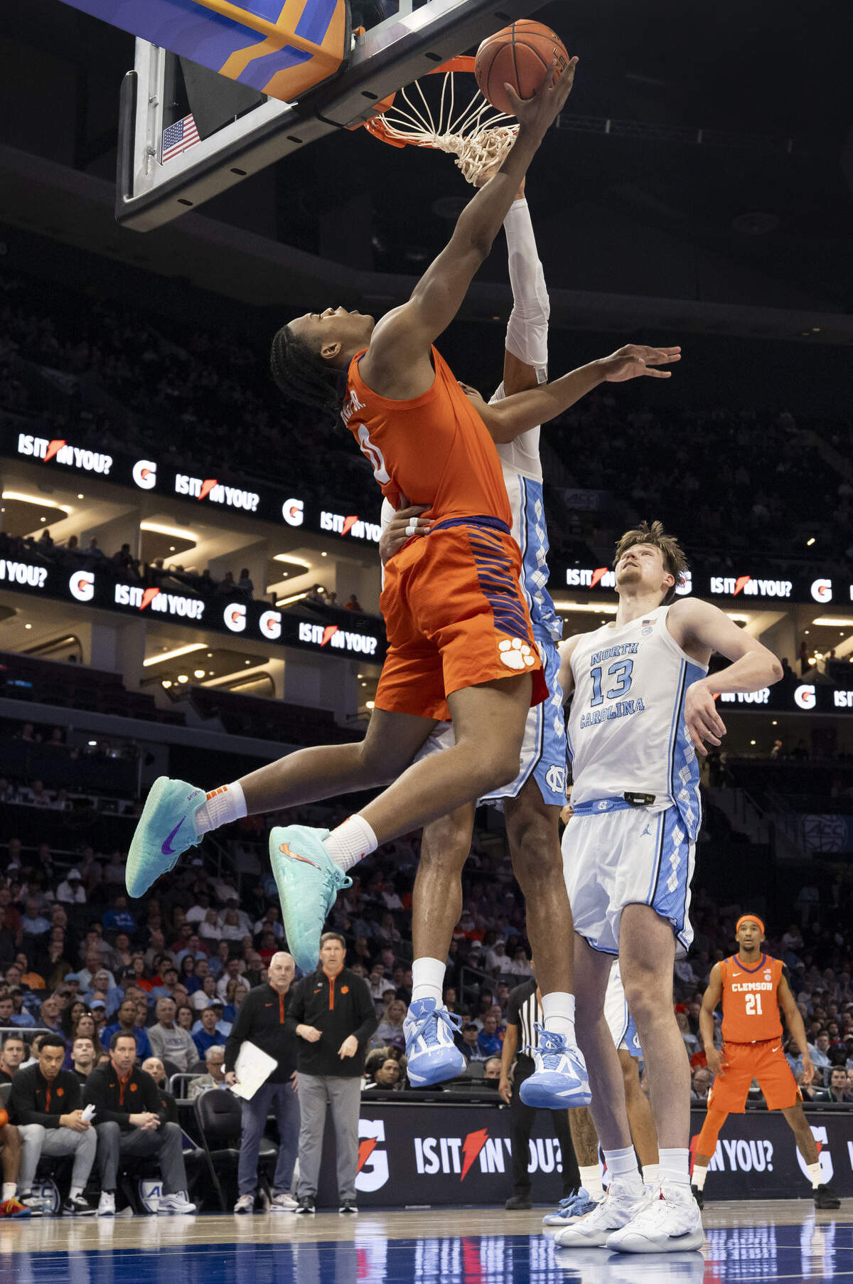 Clemson forward R J Godfrey (0) drives to the basket for a reverse lay-up against North Carolina forward Jarin Stevenson (15) in the first half during the quarterfinals of the ACC Tournament at Spectrum Center in Charlotte, N.C.