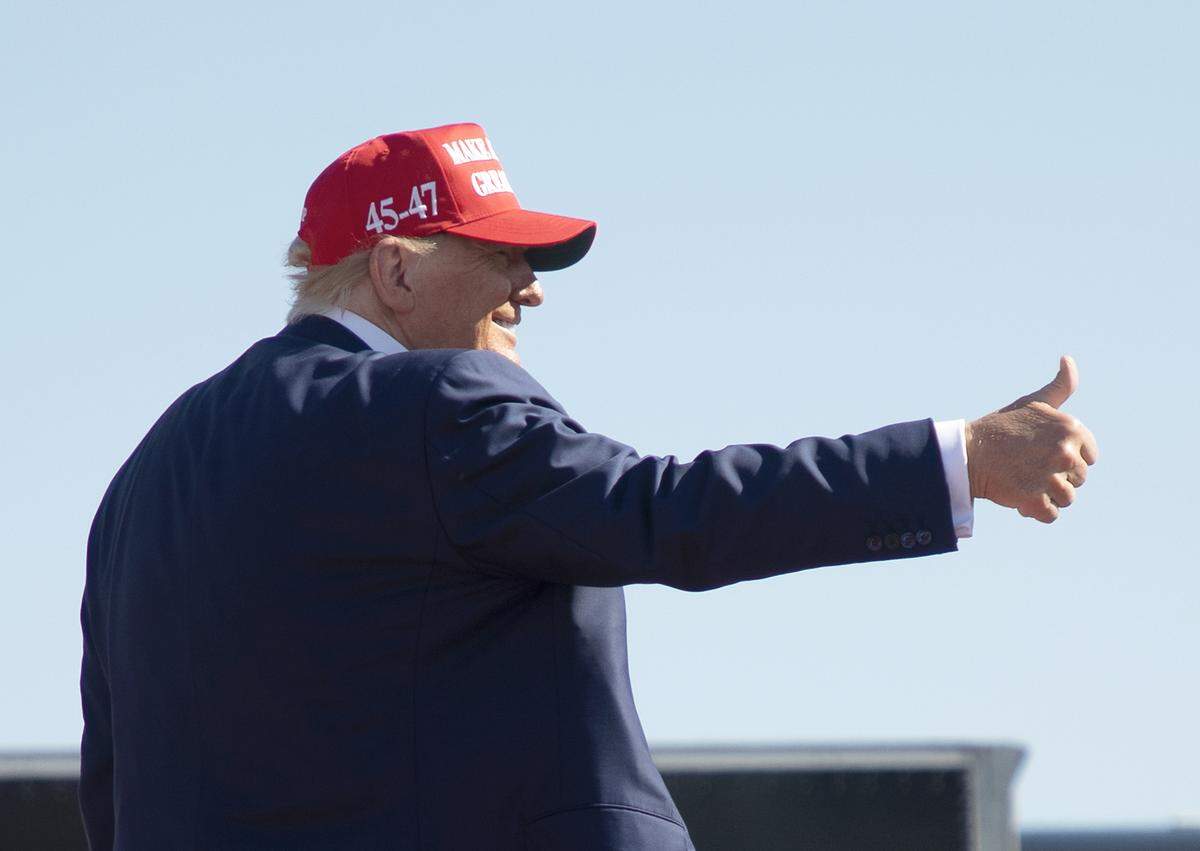Former President and current Republican candidate for president Donald Trump gives a thumbs up before departing a rally in Wilmington, N.C. on Saturday, Sept. 21, 2024.