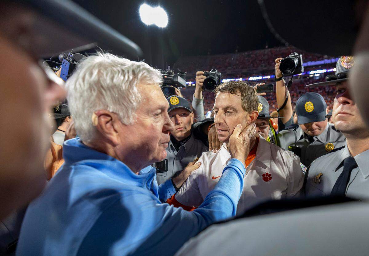North Carolina coach Mack Brown congratulates Clemson coach Dabo Swinney following the Tigers’ 31-20 victory on Saturday, November 18, 2023 at Memorial Stadium in Clemson, S.C.