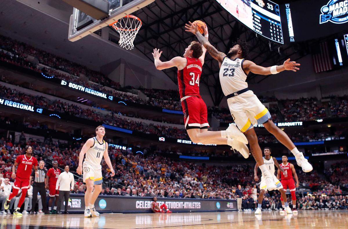 N.C. State’s Ben Middlebrooks (34) heads past Marquette’s David Joplin (23) to slam in two during N.C. State’s 67-58 victory over Marquette in their NCAA Tournament Sweet 16 game at the American Airlines Center in Dallas, Texas, Friday, March 29, 2024.