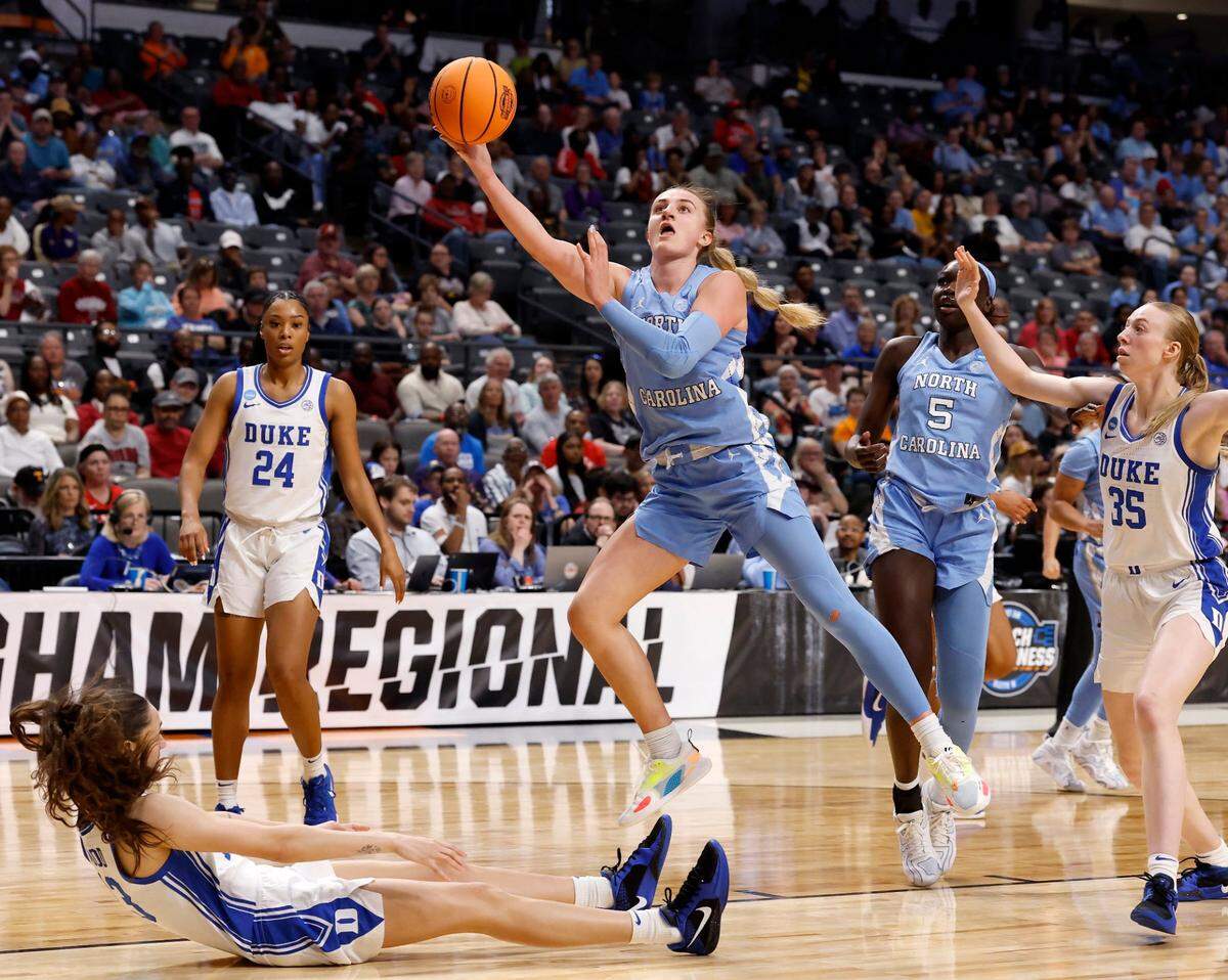 North Carolina’s Alyssa Ustby drives to the basket past Duke’s Jordan Wood and Toby Fournier during the first half of the teams’ NCAA Tournament Sweet 16 matchup at Legacy Arena on Friday, March 28, 2025, in Birmingham, Ala.