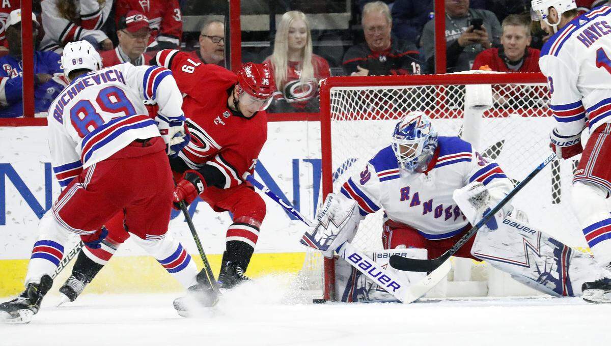 Carolina Hurricanes’ Micheal Ferland (79) is defended by New York Rangers’ Pavel Buchnevich (89) from Russia and Henrik Lundqvist (30) of Sweden during the first period of an NHL hockey game in Raleigh, N.C., Tuesday, Feb. 19, 2019.