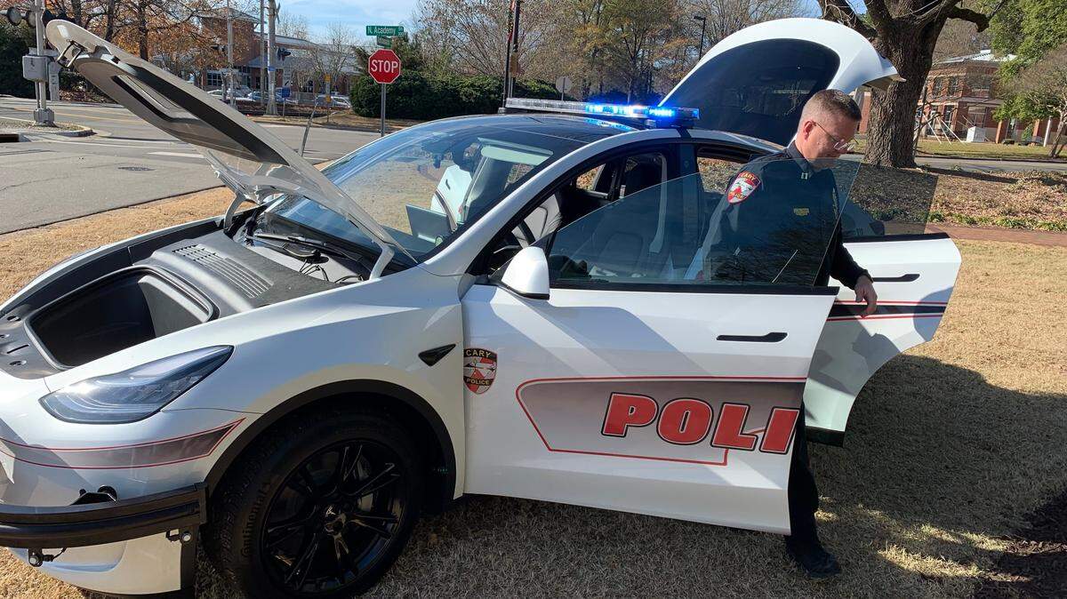 Capt. Brian Smith, who heads the Cary Police Department’s professional standards bureau, emerges from one of the department’s two new Tesla Model Y patrol cars on Dec. 16, 2021.