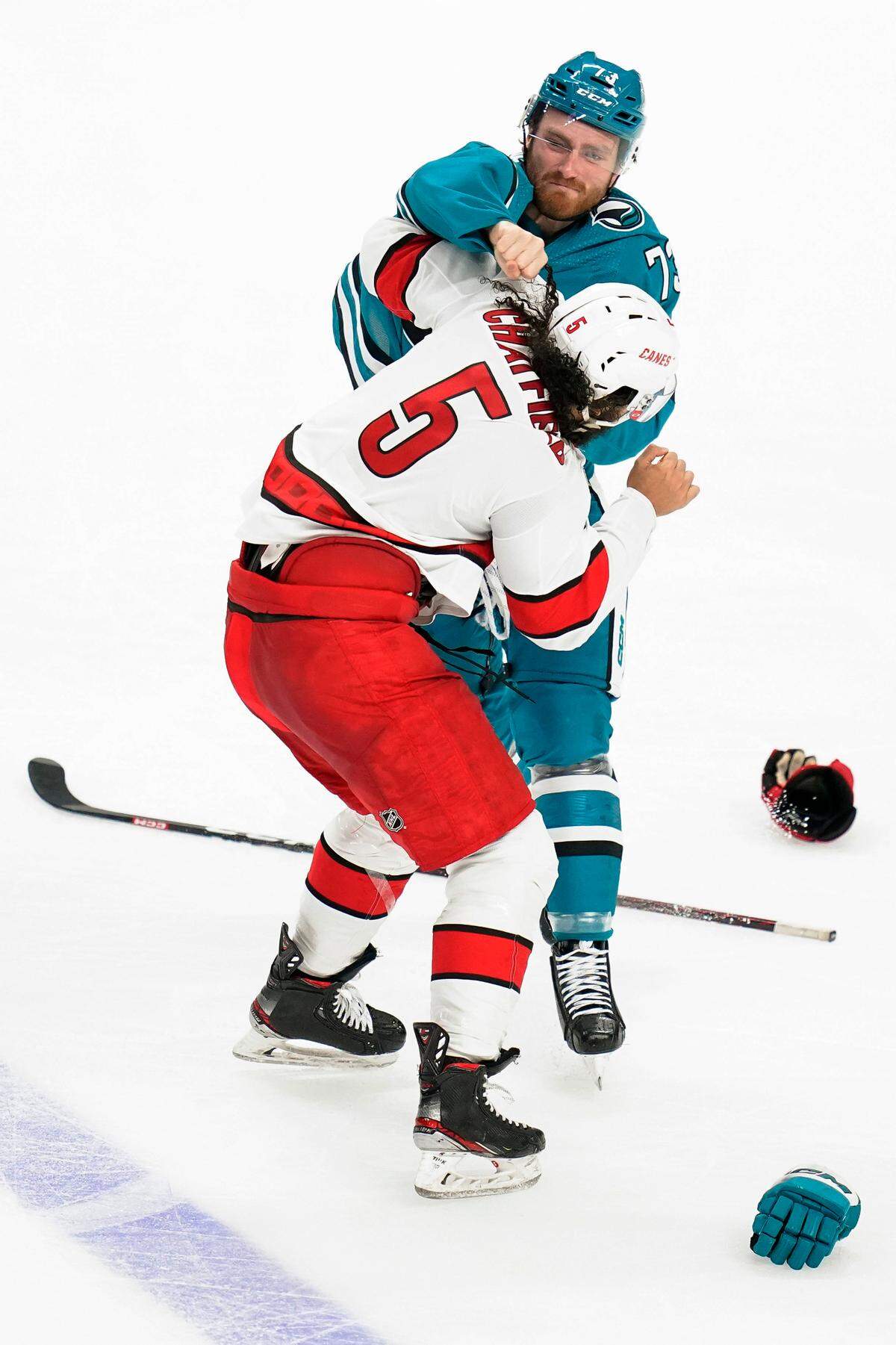 San Jose Sharks center Noah Gregor, rear, and Carolina Hurricanes defenseman Jalen Chatfield (5) fight during the third period of an NHL hockey game in San Jose, Calif., Friday, Oct. 14, 2022. (AP Photo/Godofredo A. V·squez)