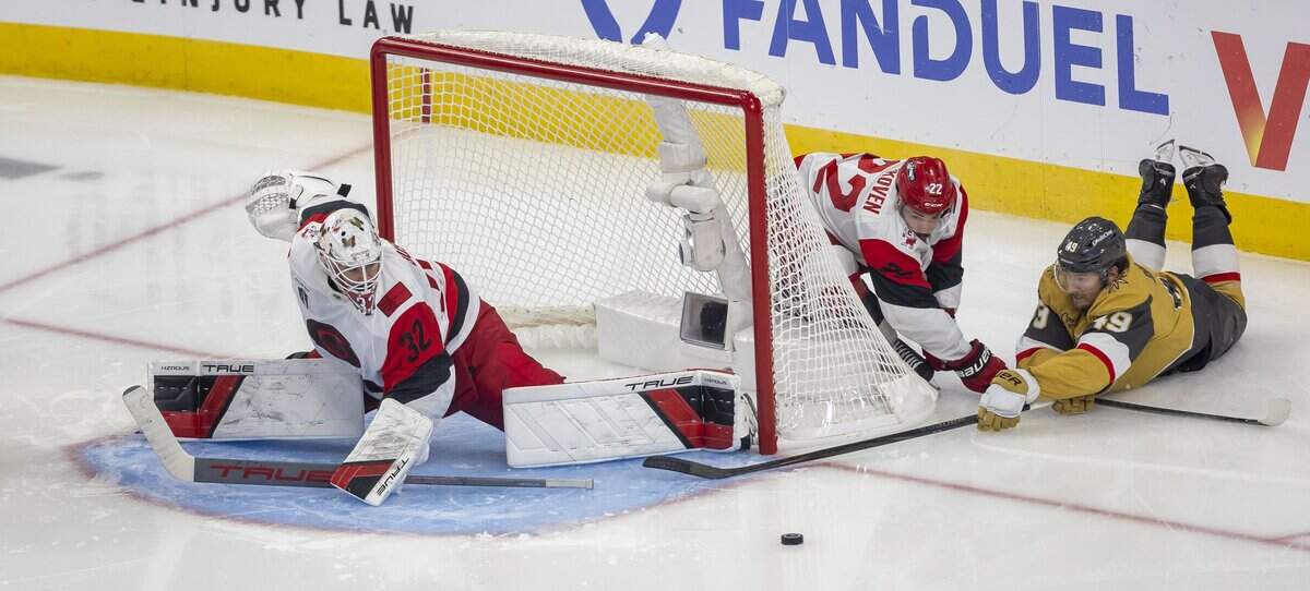 Carolina Hurricanes center Logan Stankoven (22) defends Vegas left wing Ivan Barbashev (49) as he tries score on a warp around, on goalie Brandon Bussi (32) in the third period of Game 4 of the Stanley Cup Final, on Tuesday, June 9, 2026 in Las Vegas, NV.