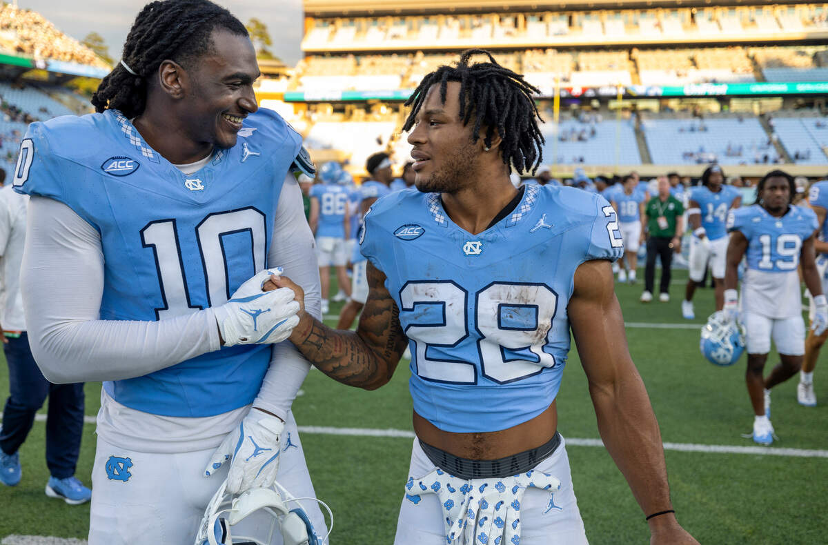 North Carolina running back Omarion Hampton (28) celebrates the Tar Heels’ 38-20 victory over Charlotte with defensive lineman Desmond Evans (10) on Saturday, September 7, 2024 at Kenan Stadium in Chapel Hill, N.C.