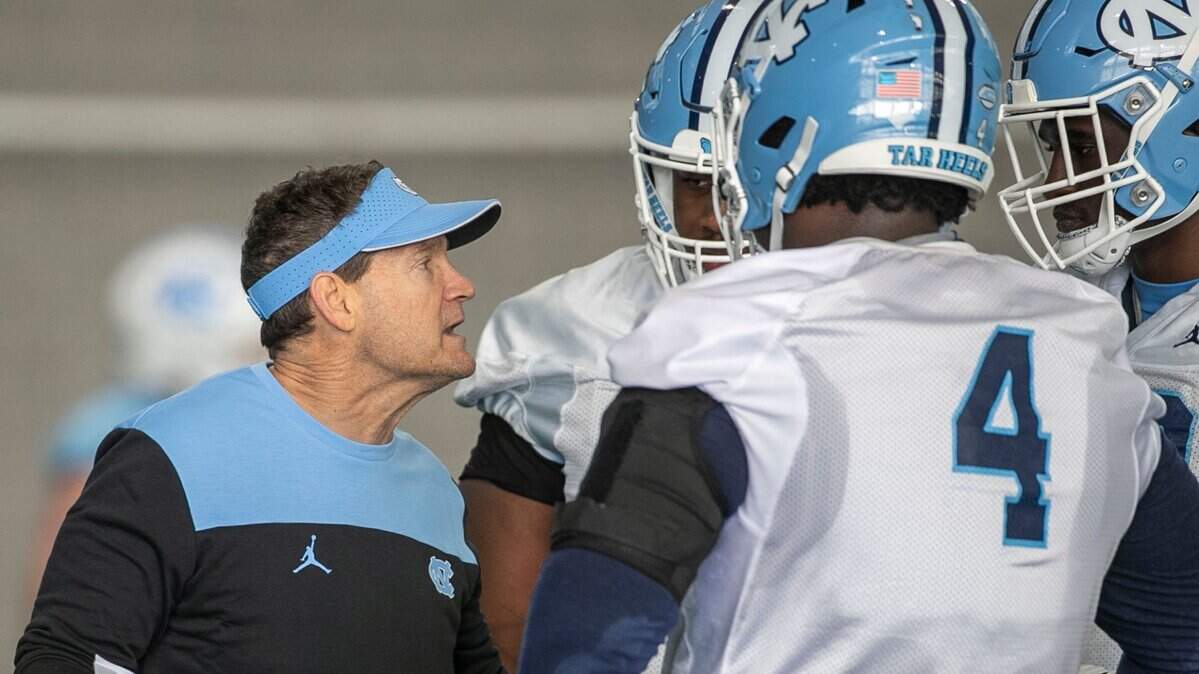 North Carolina assistant head coach for defense, Gene Chizik, works with defensive linemen during the opening day of the Tar Heels’ spring football practice on Tuesday, March 1, 2022 in Chapel Hill, N.C.