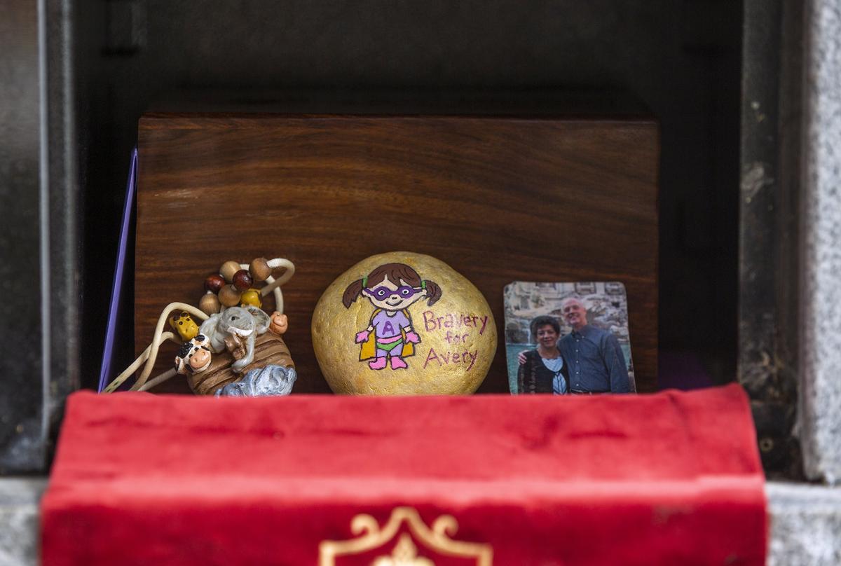 Family members leave tokens with the urn containing the ashes of five-year-old Avery Neill who died on Mother’s Day, May 13, 2018, of an incurable brain tumor known as DIPG, during her internment service on Saturday, May 19, 2018, at Bayleaf Baptist Church in Raleigh, NC.