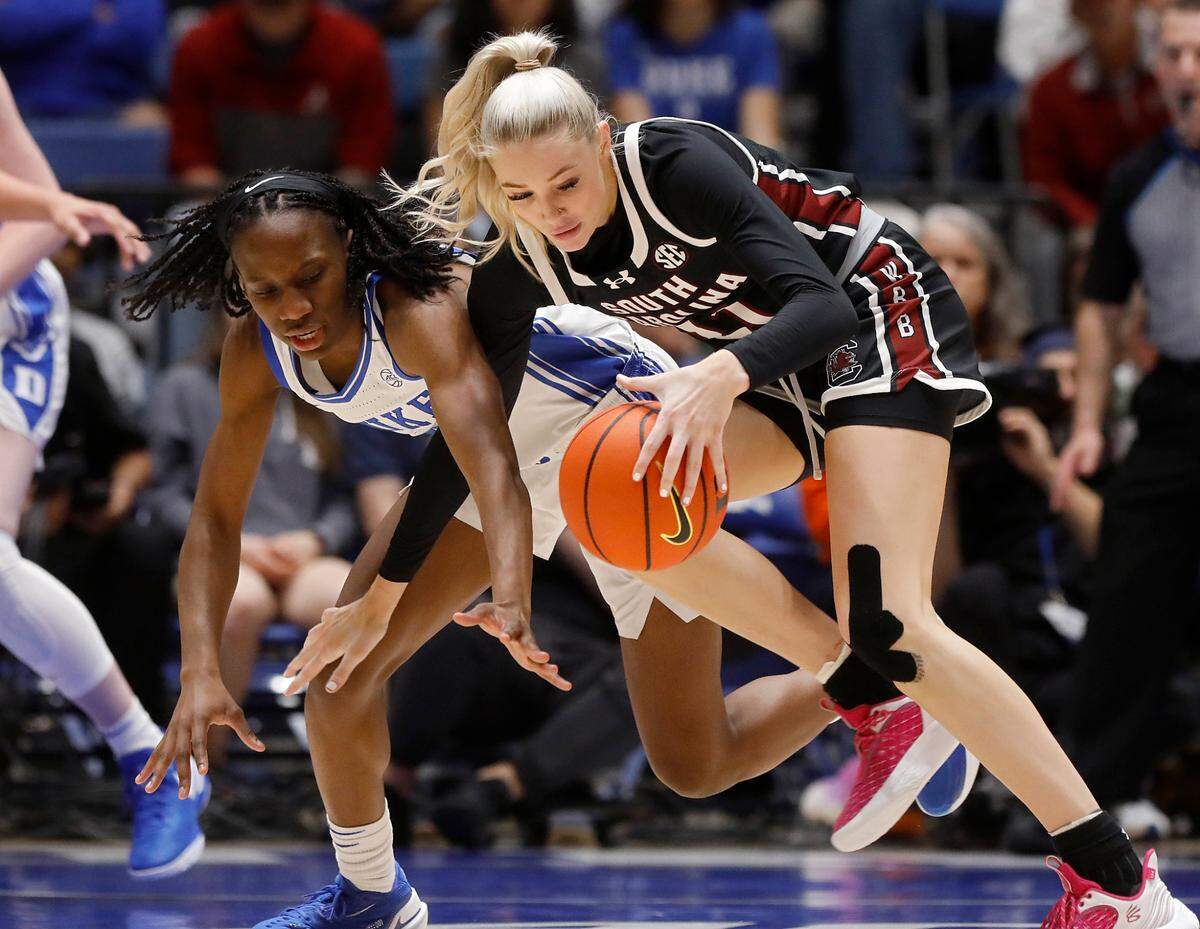Duke’s Jadyn Donovan and South Carolina’s Chloe Kitts lunge for a loose ball during the first half of the Blue Devils’ game on Sunday, Dec. 3, 2023, at Cameron Indoor Stadium in Durham, N.C.