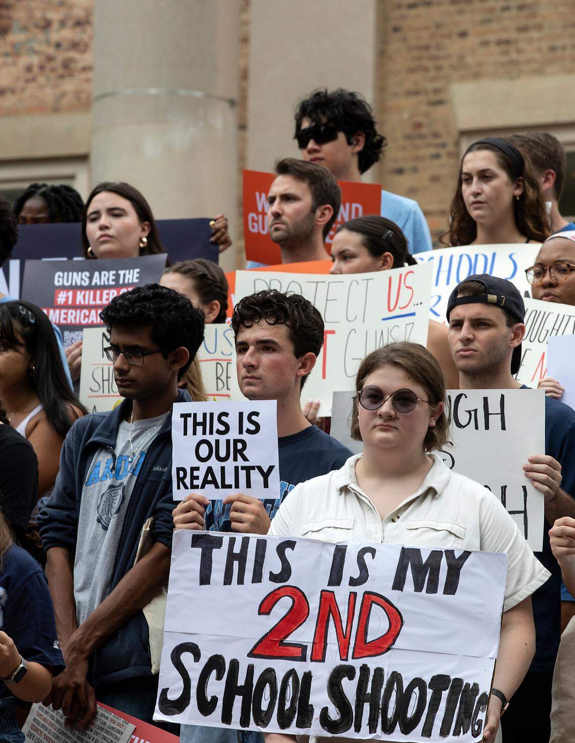 People hold signs during a student-led rally at UNC-Chapel Hill in support of gun control on Wednesday, Aug. 30, 2023. A graduate student has been charged with first-degree murder following a Monday shooting that left physics professor Zijie Yan dead on the university’s campus.