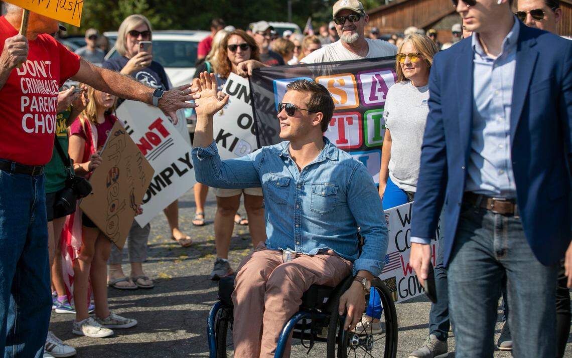 U.S. Rep. Madison Cawthorn is greeted by demonstrators as he arrives to lead them to the Johnston County Board of Education meeting on Tuesday, September 14, 2021 in Smithfield, N.C. Cawthorn came to urge the school district to end the face covering mandate for students.