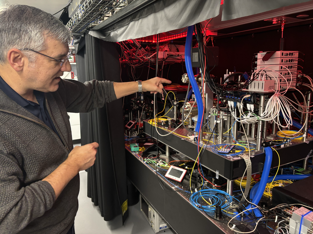 Chris Monroe, director of the Duke Quantum Center, displays a trapped-ion quantum computer in Durham on Dec. 16, 2024. 