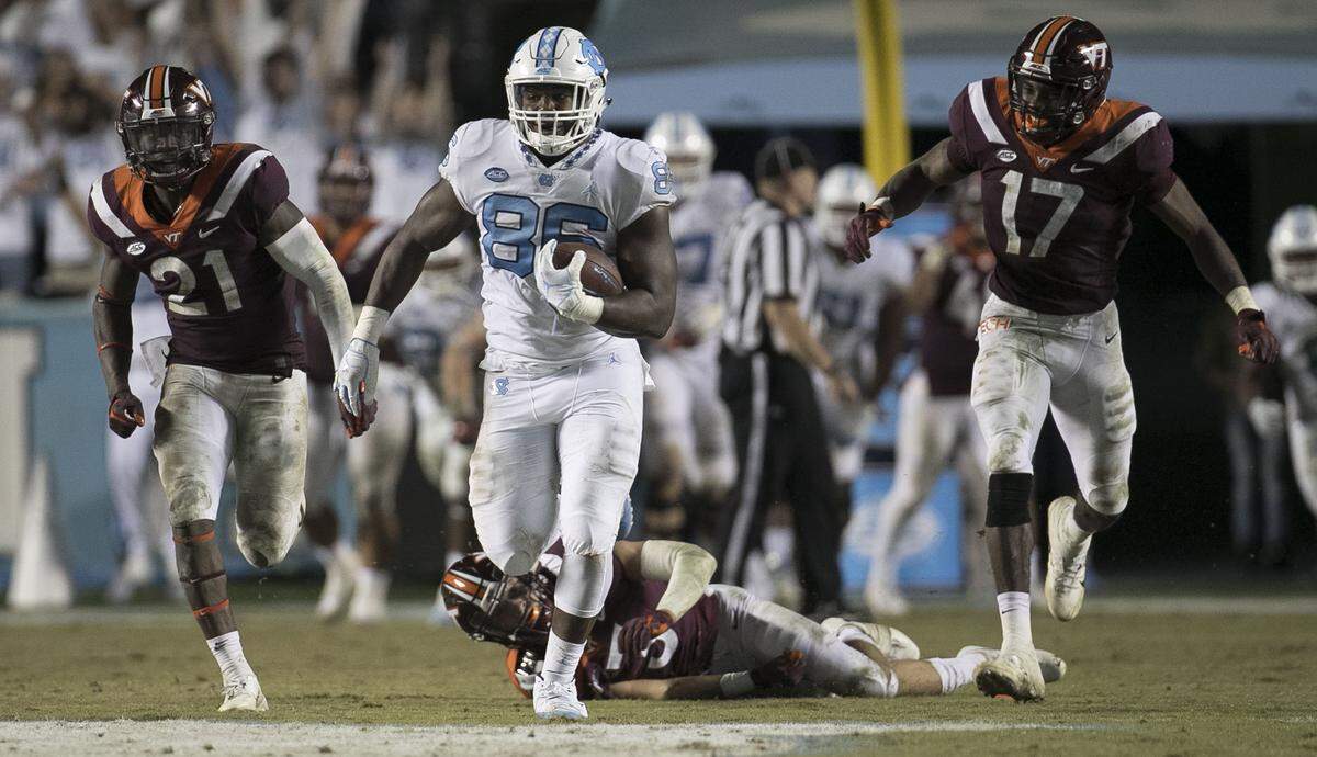 North Carolina’s Carl Tucker (86) picks up 80 yards on a pass completion from quarterback Nathan Elliott in the fourth quarter against Virginia Tech on Saturday, October 13, 2018 at Kenan Stadium in Chapel Hill, N.C.