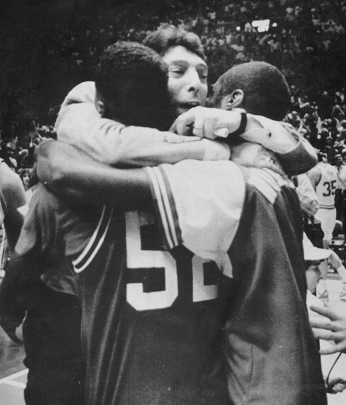 Jim Valvano hugs two of his players after NCSU wins the ACC Tournament in 1987.