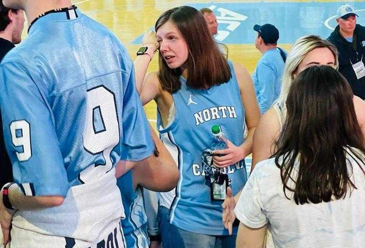UNC fan Sarah McIlroy wipes her eye after the Tar Heels’ loss to Kansas in the national championship game on April 4.