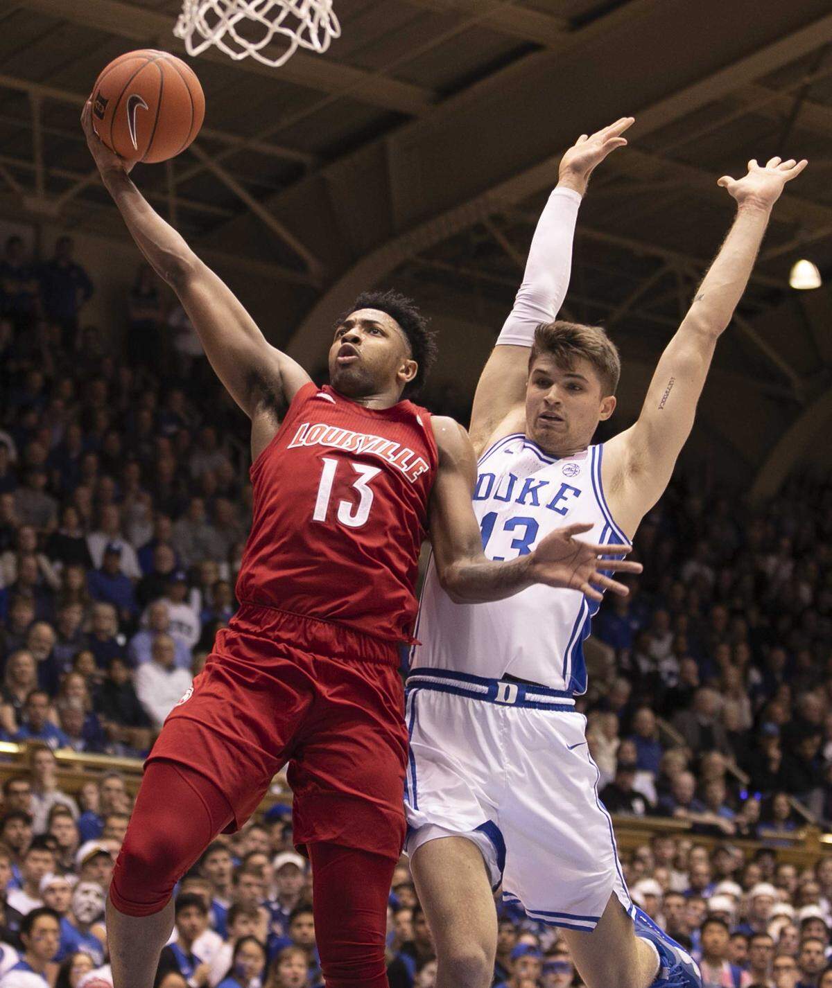 Louisville’s David Johnson (13) drives to the basket against Duke’s Joey Baker (13) during the first half on Saturday, January 18, 2020 at Cameron Indoor Stadium in Durham, N.C. Johnson scored 17 points in the first half.