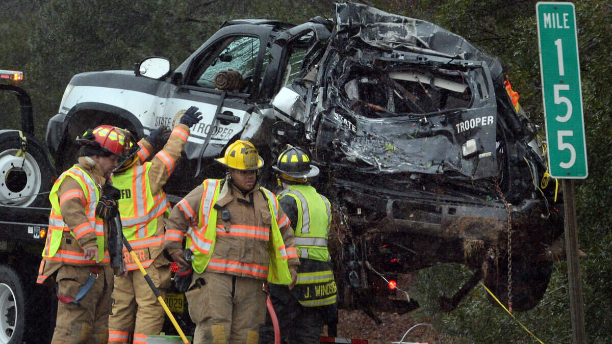 A North Carolina Highway Patrol SUV sits atop a wrecker as firefighters work to clear debris in the northbound lane of I-40/85 near Mebane in 2014. Jurors in federal court awarded Trooper D.C. Justice $7 million.