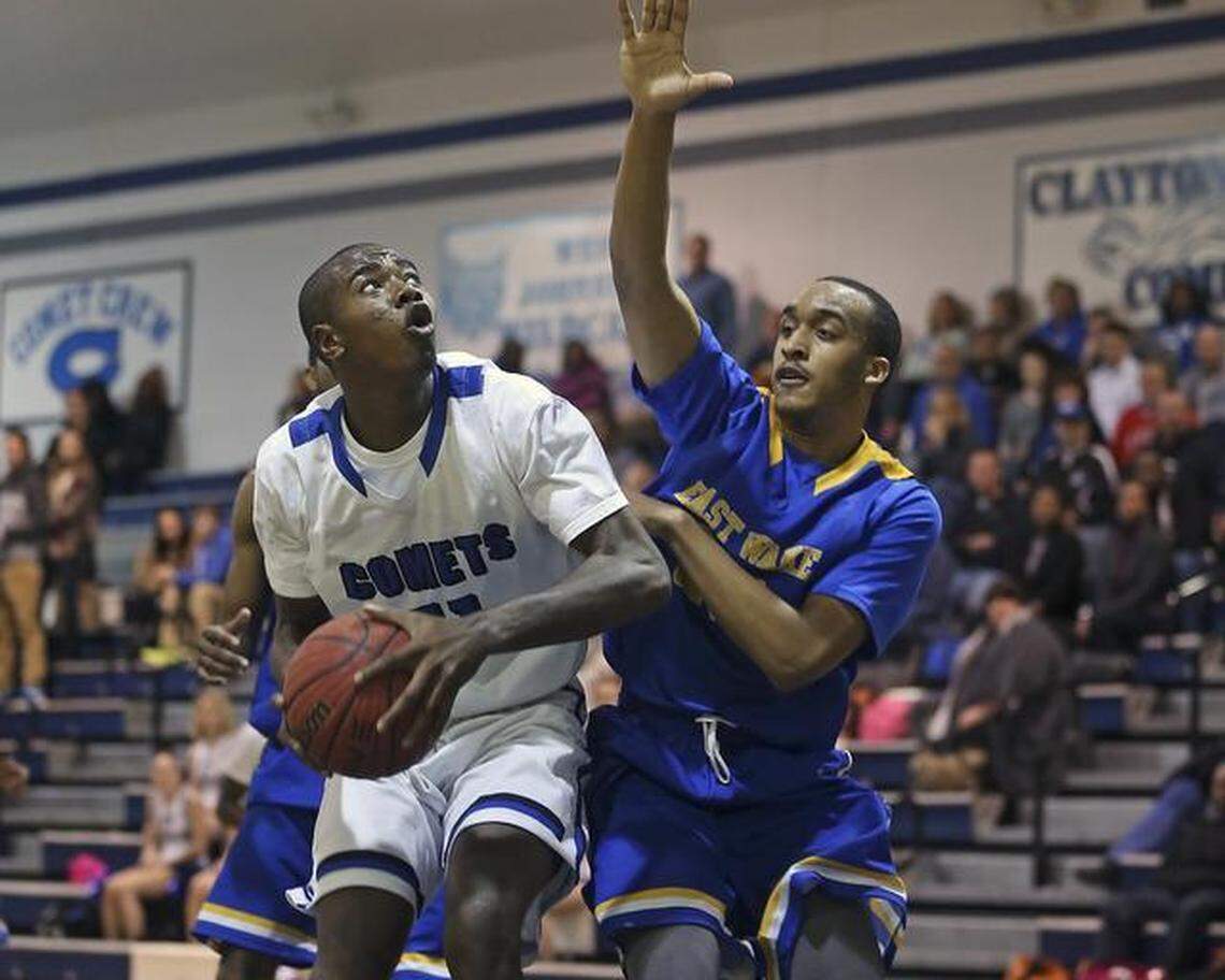 Clayton’s Gary Clark, left, looks to the basket as East Wake defender Jonathon High tries to make the stop on Tuesday.