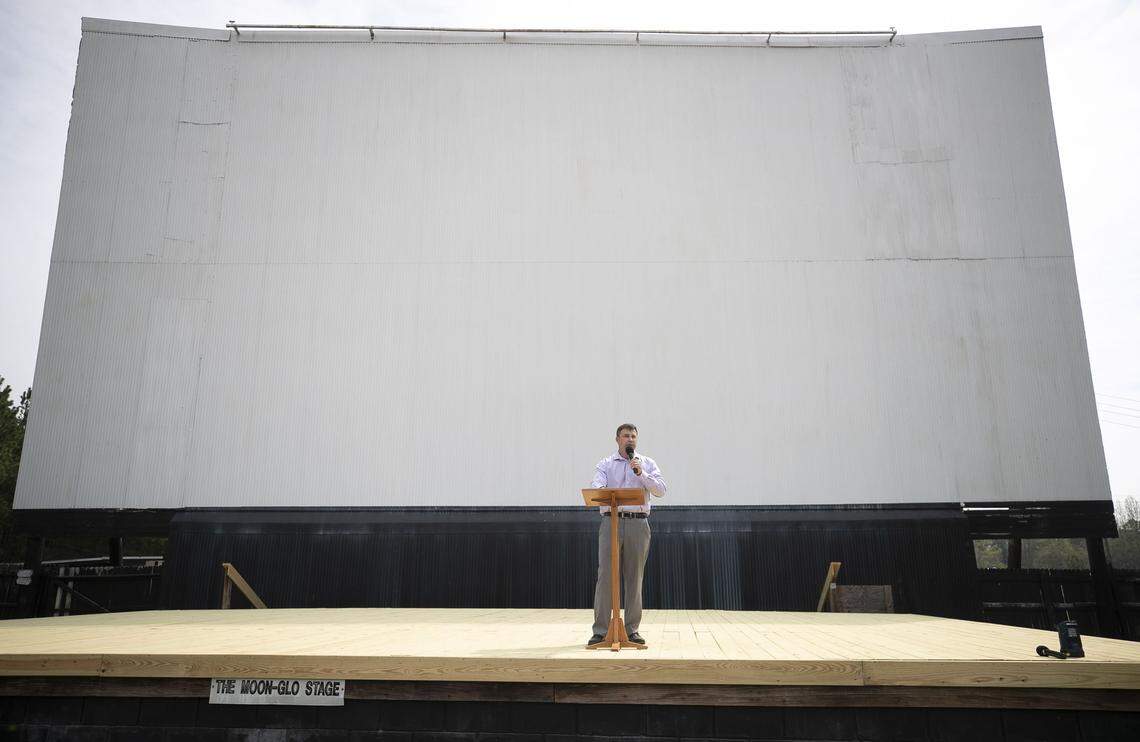 Pastor Will Breedlove of the Harriett Baptist Church in Henderson, N.C. delivers his sermon to his congregation beneath the big screen at the Raleigh Road Outdoor Theatre in Henderson, N.C., on Sunday, March 29, 2020 in Henderson, N.C.