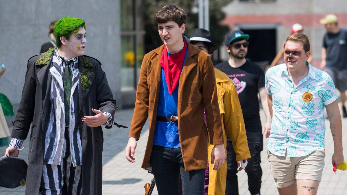 A group of friends walks towards the Raleigh Convention Center for GalaxyCon on Thursday, July 29, 2021.