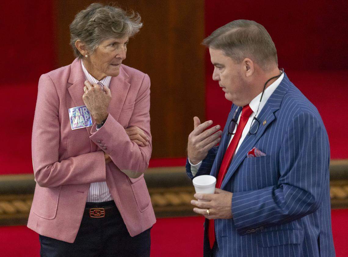 Rep. Pricey Harrison, sporting a ‘Fair Map’ sticker, talks with Rep. Brenden H. Jones prior to the House session, where Senate Bill 249, a bill to realign the North Carolina Congressional districts was scheduled for debate, on Wednesday, October 22, 2025 at the General Assembly in Raleigh, N.C.
