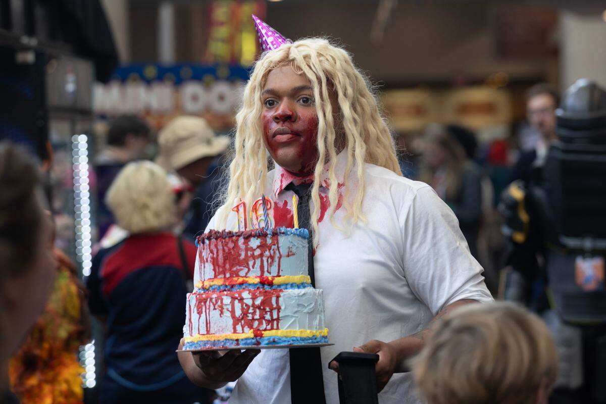 Jordan McKenzie holds a handmade cake replica at Galaxycon at the Raleigh, N.C. Convention Center on Friday, July 25, 2025.
