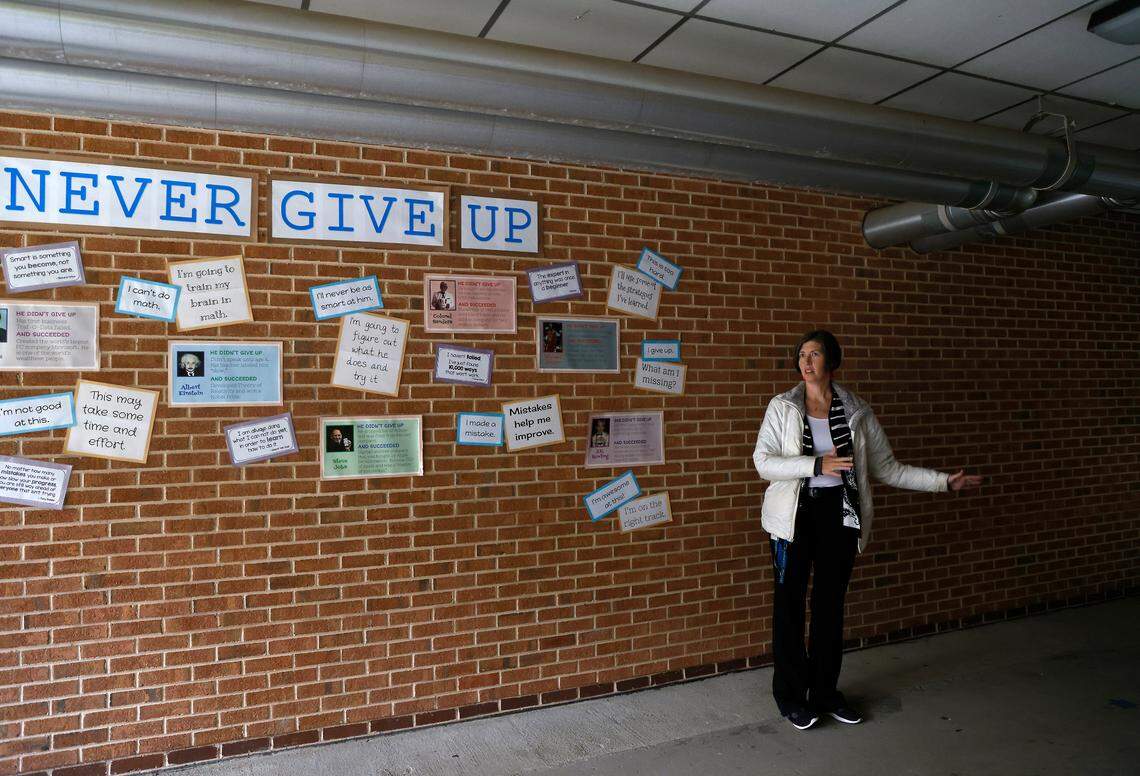 Emily Hardee, assistant principal at Brentwood Elementary School, stands in an outdoor walkway where rainwater pools after storms on Wednesday, Oct. 12, 2022, in Raleigh, N.C. Brentwood Elementary is one of seven schools that would undergo renovations in a $530.7 million bond referendum on the Nov. 8 ballot.