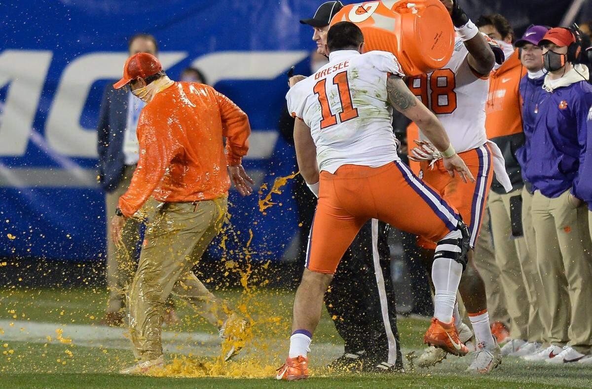 Clemson Tigers head coach Dabo Swinney, left, receives a gatorade bath in the closing moments of the ACC Championship game. Clemson defeated Notre Dame 34-10 to win the championship at Bank of America Stadium in Charlotte, NC on Saturday, December 19, 2020.  