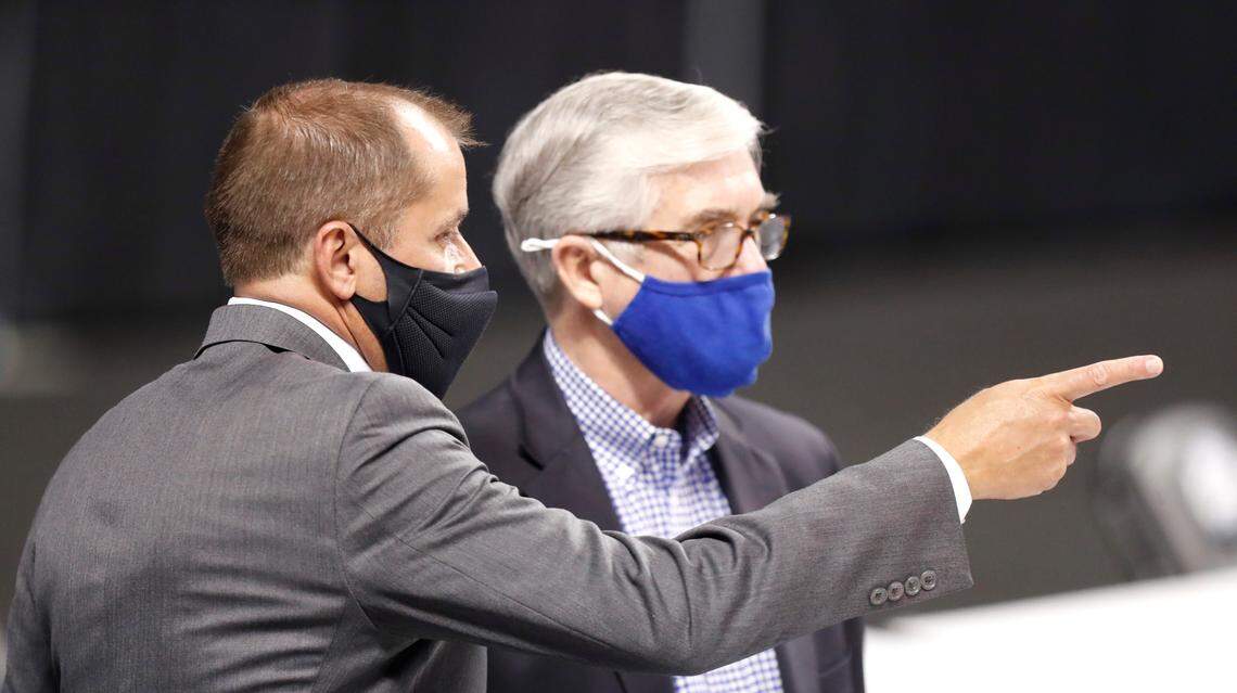 ACC Commissioner Jim Phillips talks with Kevin White, Duke’s director of athletics, before Duke’s game against Boston College in the first round of the ACC Men’s Basketball Tournament in Greensboro, N.C., Tuesday, March 9, 2021.