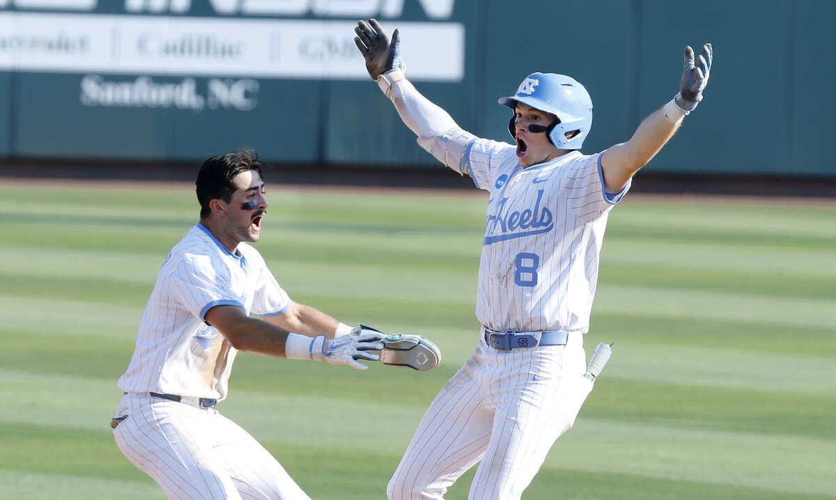 North Carolina's Gavin Gallaher (5) celebrates with Owen Hull (8) after Hull made the winning hit in UNC’s 4-3 victory over USC at Boshamer Stadium to win the Chapel Hill Super Regional Sunday, June 7, 2026.