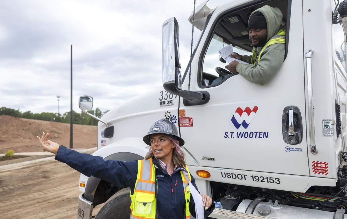 Construction project manager Sam Roth, directs a delivery of concrete at the Veridea mixed use development site on Tuesday, April 28, 2026 in Apex, N.C. 