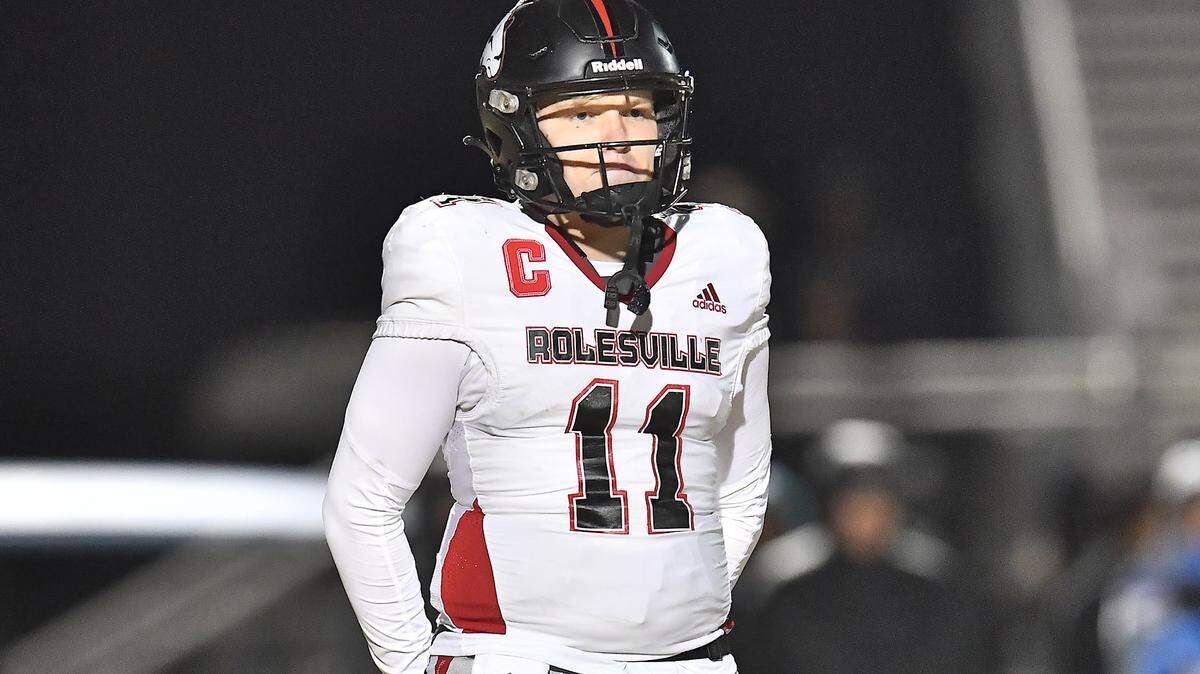 Rolesville quarterback Braden Atkinson (11) looks to the sidelines in between plays against Cleveland during the first half. The Rolesville Rams and the Cleveland Rams met in the fourth round of the NCHSAA 4A football playoffs in Clayton, N.C. on December 6, 2024.