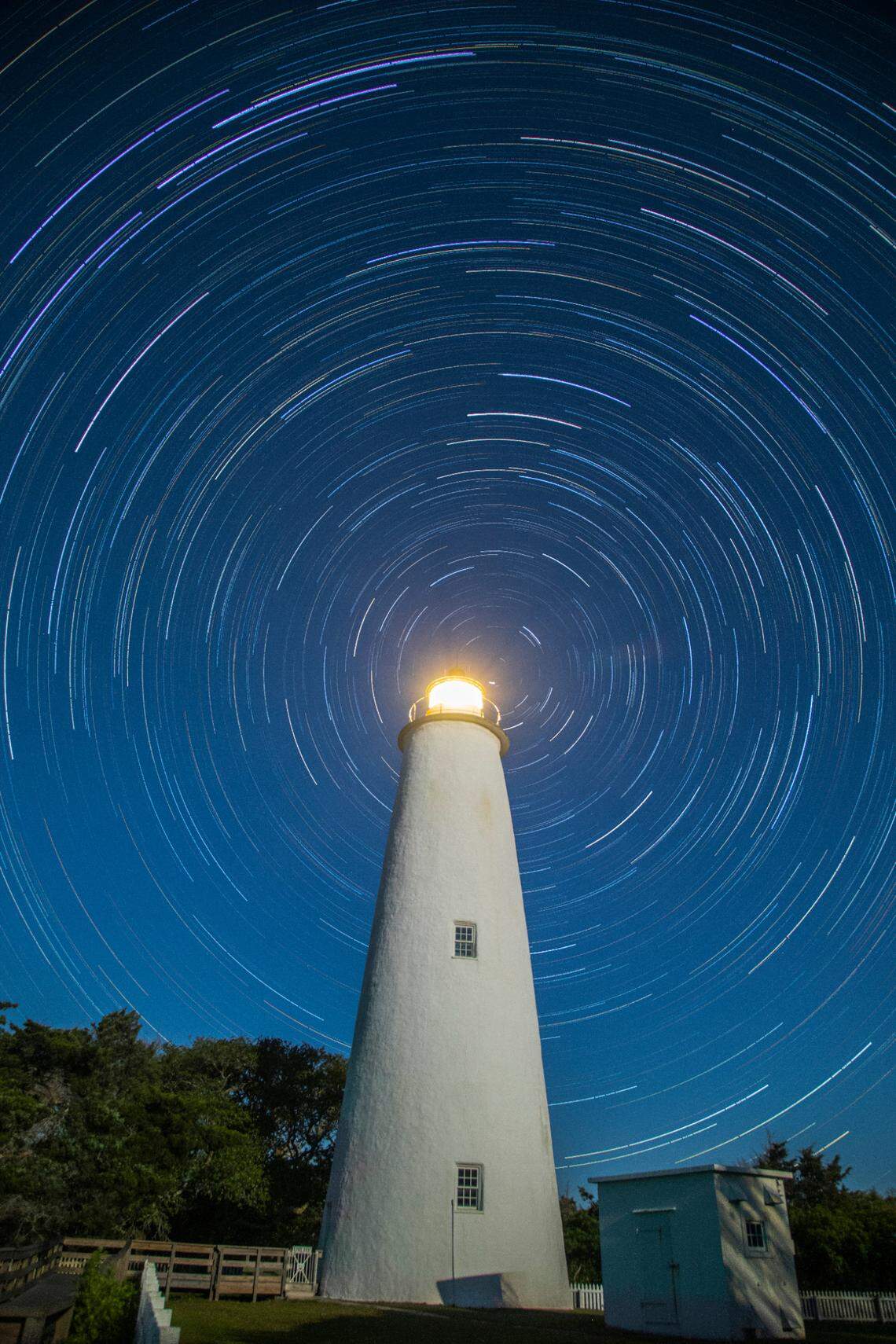 A composite image of more than 170 long exposures shows the rotation of the earth in the night sky behind the Ocracoke Light Station in Ocracoke Tuesday, May 17, 2022. The lighthouse is the second-oldest operating lighthouse in the nation.