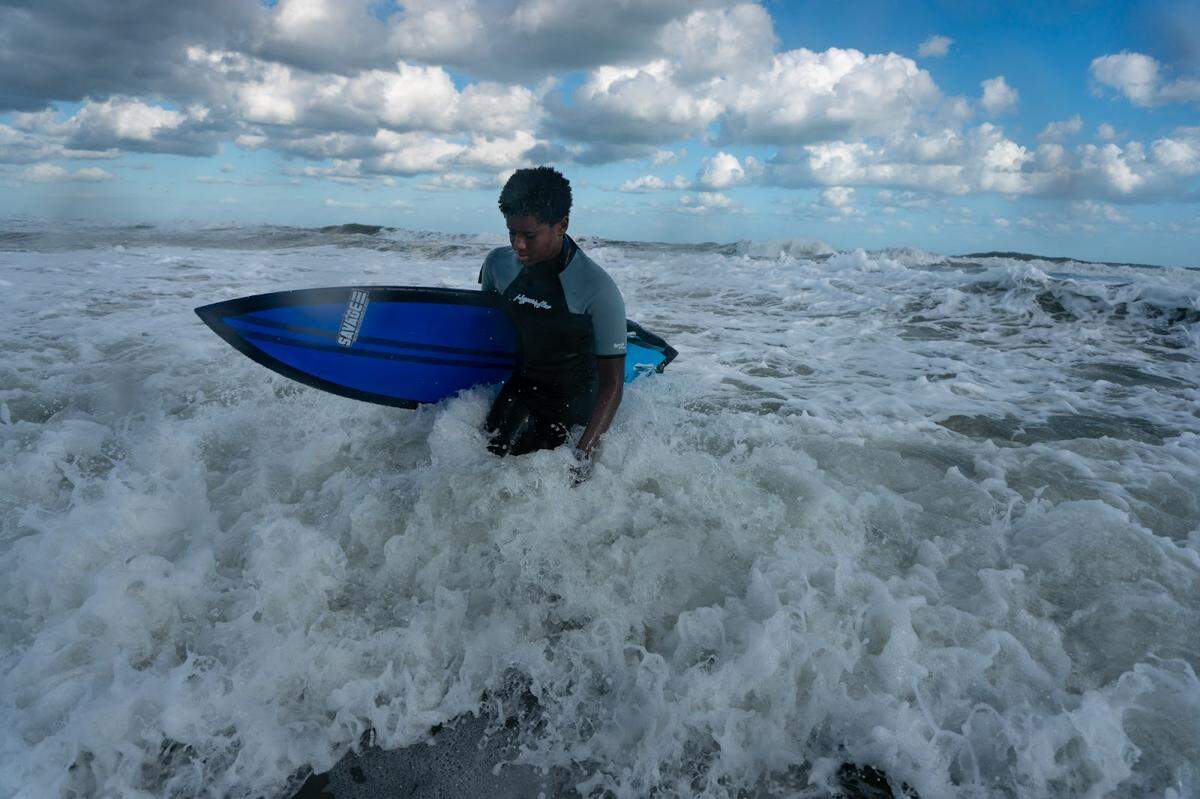 Sterling Stewart in the ocean at Wrightsville Beach. He took part in Surfers Healing, a camp teaching kids with autism how to surf. Today he surfs at least four days a week, and his family moved from Durham to Wilmington so he would be closer to the ocean.