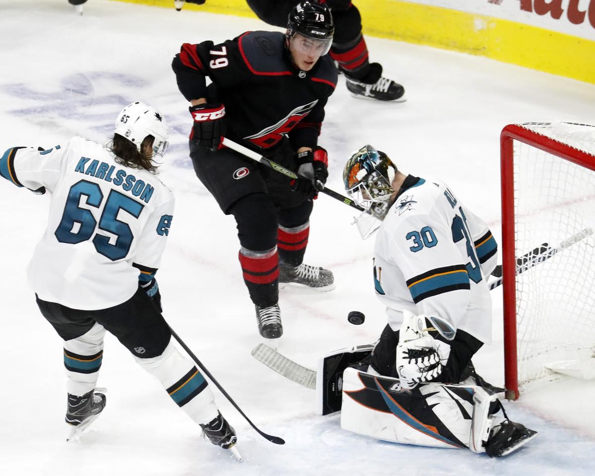 San Jose Sharks’ Erik Karlsson (65) of Sweden and Aaron Dell (30) defend the Carolina Hurricanes’ Micheal Ferland (79) during the second period of an NHL hockey game in Raleigh, N.C. Friday, Oct. 26, 2018. 