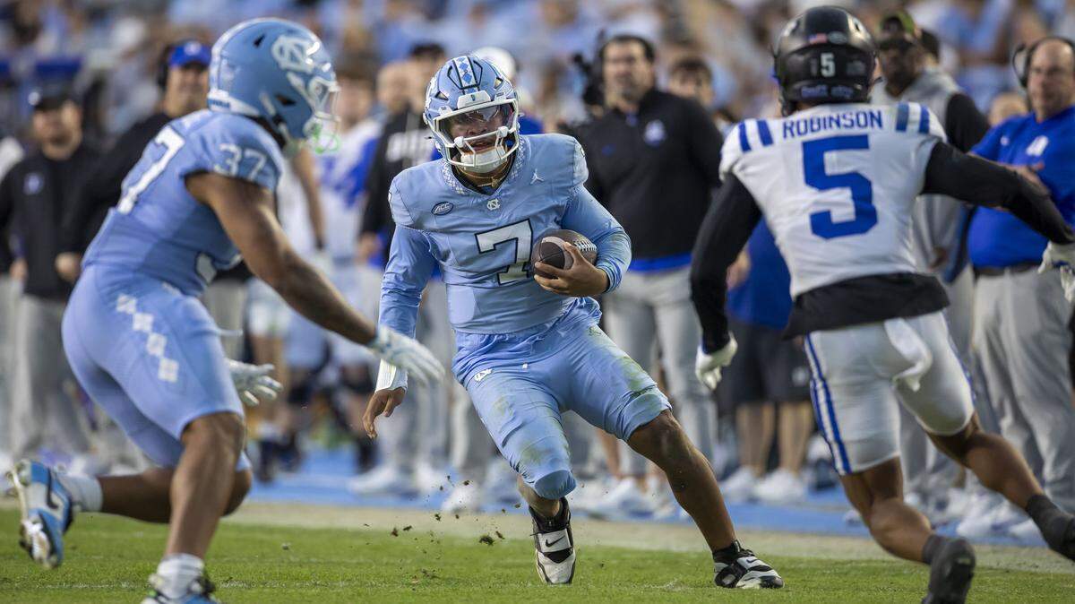 North Carolina quarterback Gio Lopez (7) looks for running room on a 21-yard gain against Duke in the second quarter on Saturday, November 22, 2025 at Kenan Stadium in Chapel Hill, N.C.