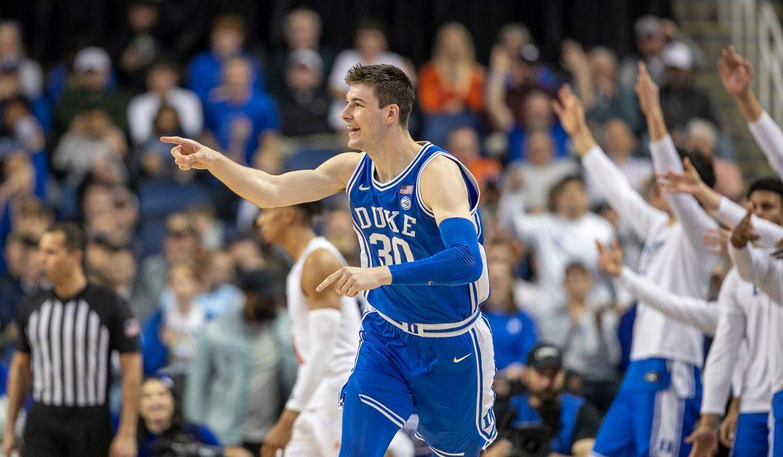Duke’s Kyle Filipowski (30) reacts after sinking a there point basket to give the Blue Devils a 58-52 lead in the second half against Miami during in the semi-finals of the ACC Tournament on Friday, March 10, 2023 at the Greensboro Coliseum in Greensboro, N.C. Filipowski lead Duke with 17 points in their 85-78 victory.