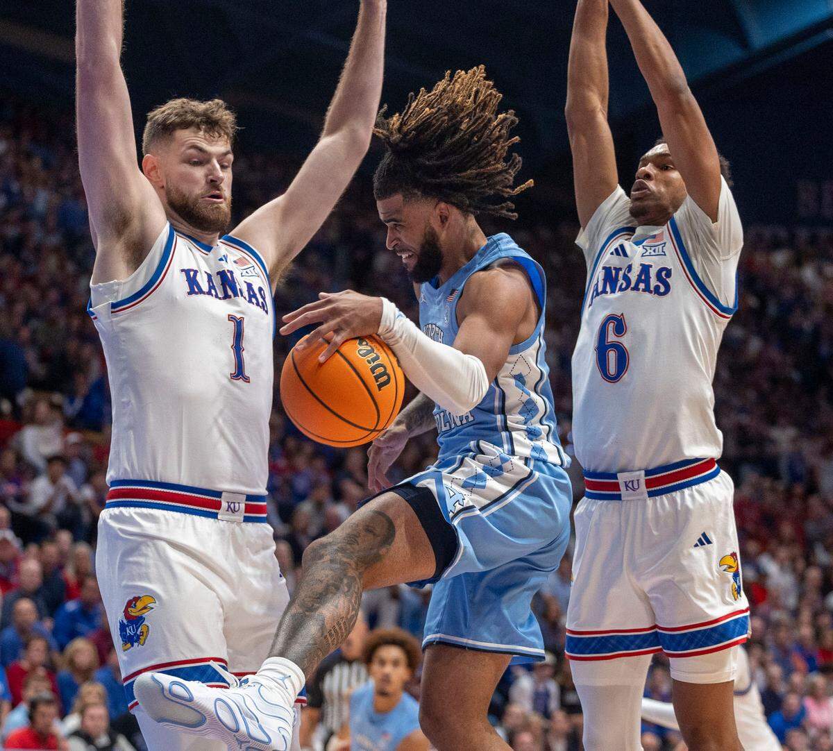 Kansas center Hunter Dickinson (1) and guard Rylan Griffen (6) trap North Carolina guard R.J. Davis (4) in the second half on Friday, November 8, 2024 at Allen Fieldhouse in Lawrence, Kansas.
