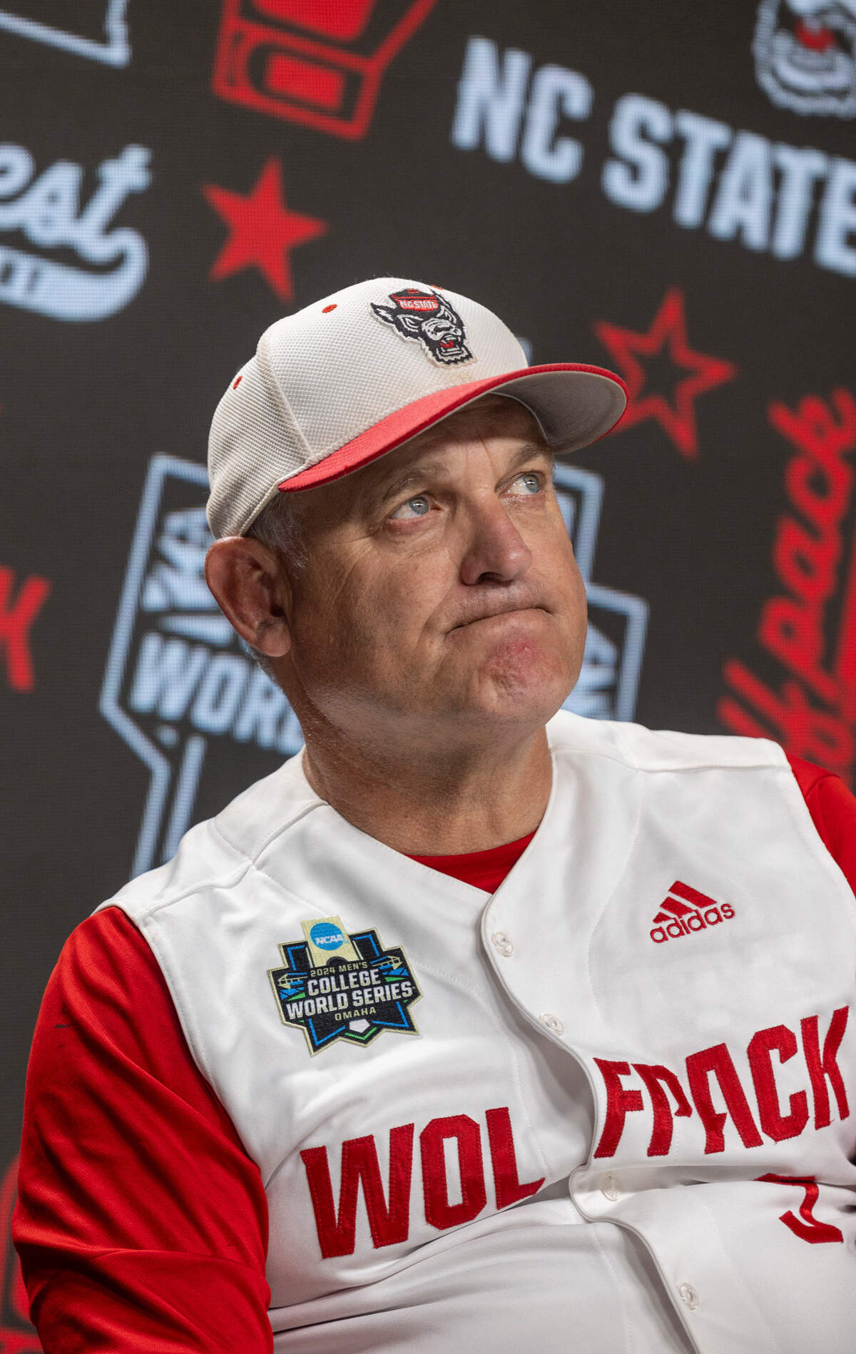 N.C. State coach Elliott Avent listens to his players during interviews with the media following the Wolfpack’s 5-4 season ending loss to Florida in game seven of the College World Series on Monday, June 17, 2024 at Charles Schwab Field in Omaha, Nebraska.