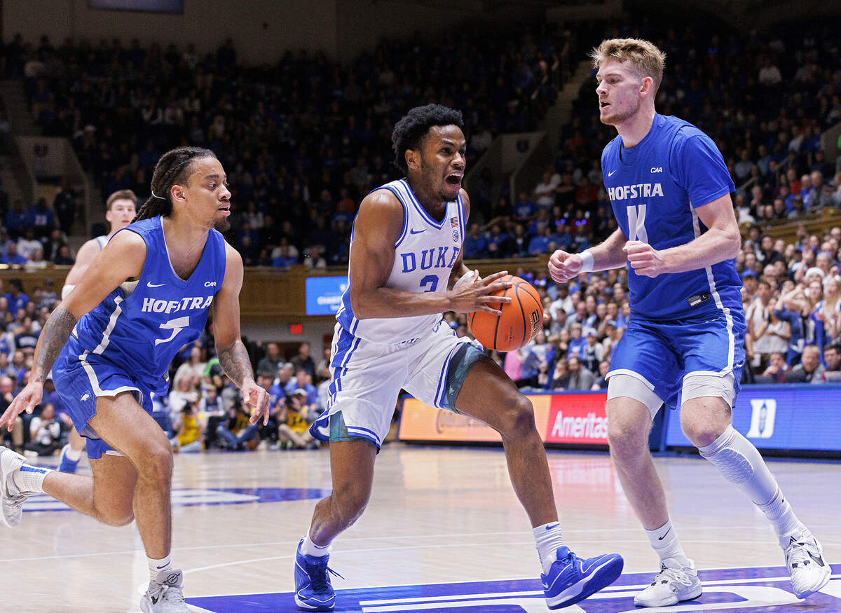 Duke’s Jeremy Roach drives between Hofstra’s Jaquan Carlos and Jacco Fritz during the first half of the Blue Devils’ game on Tuesday, Dec. 12, 2023, at Cameron Indoor Stadium in Durham, N.C.