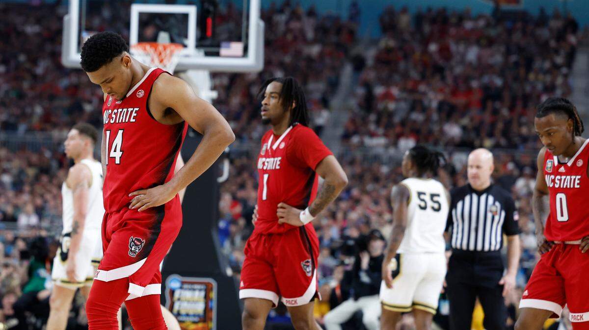 NC State’s and Casey Morsell (14), Jayden Taylor (1) and DJ Horne (0) walk to the bench during a second half timeout as they face Purdue in the Final Four, Saturday night, April 6, 2024.