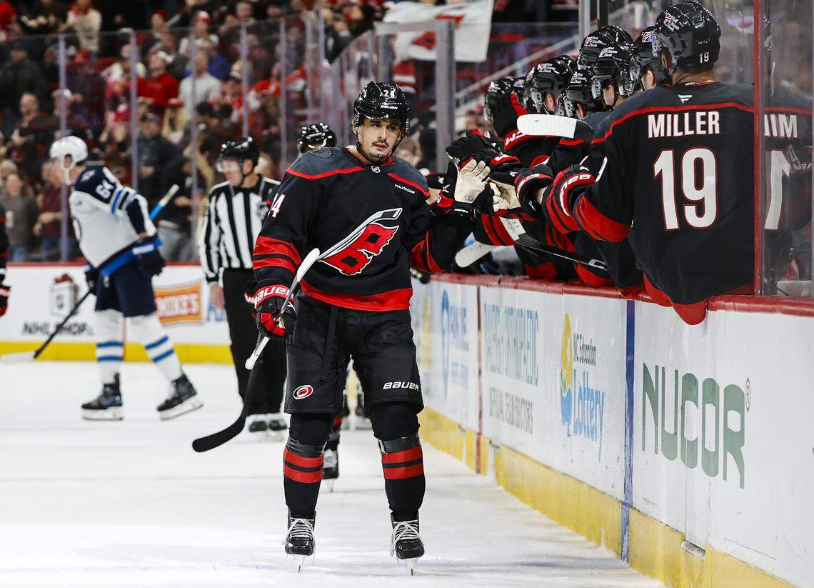 Carolina Hurricanes forward Seth Jarvis celebrates a goal with the bench during the first period against the Winnipeg Jets at Lenovo Center on Nov. 28, 2025 in Raleigh, North Carolina.