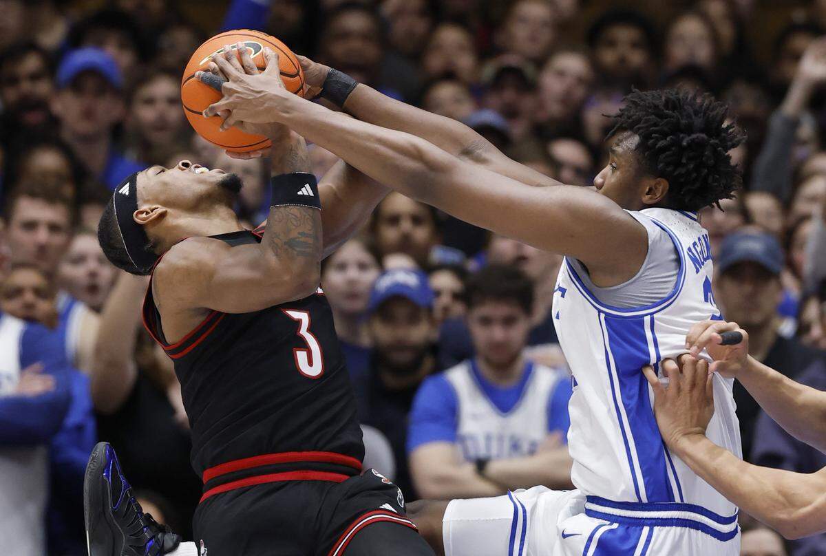 Duke’s Patrick Ngongba II (21) stops Louisville's Ryan Conwell (3) from taking the shot during the first half of Duke’s game against Louisville at Cameron Indoor Stadium in Durham, N.C., Monday, Jan. 26, 2026.