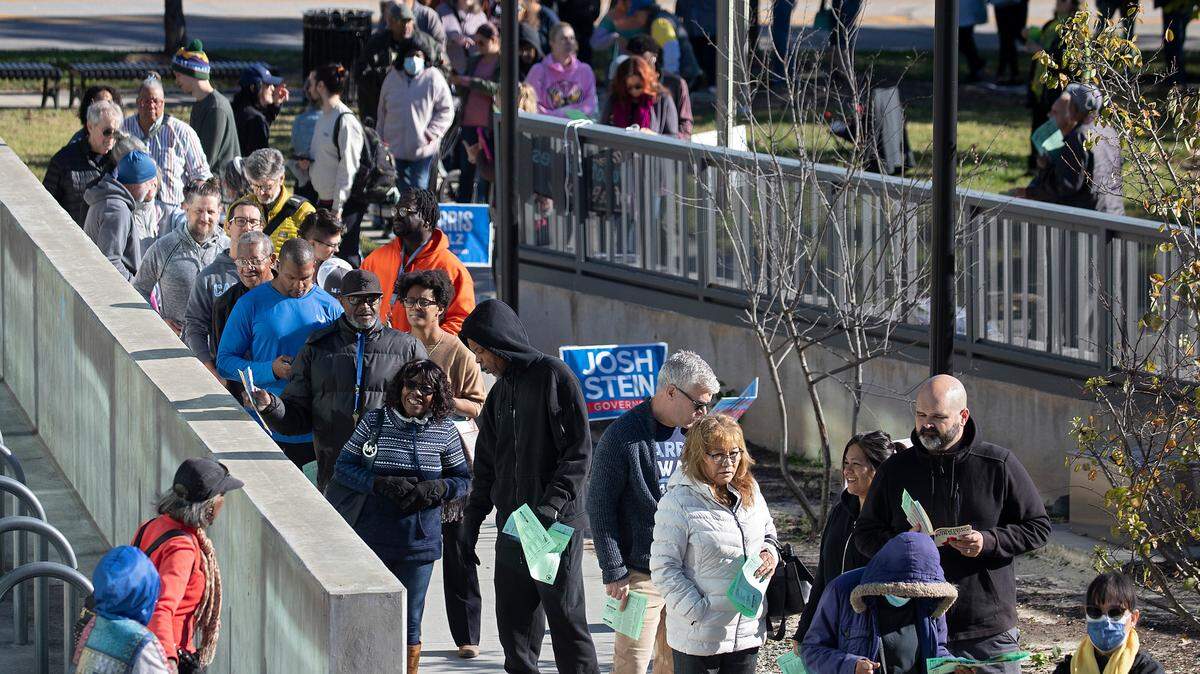 People line up to vote outside the Durham County Main Library in Durham, N.C., Thursday morning, Oct. 17, 2024, on first day of early voting in North Carolina. There are more than 400 early voting sites across the state. During the early voting period, voters can visit any early voting site in their county. While on Election Day, voters must visit their assigned polling place.