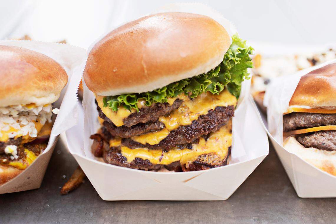 CowBar in Raleigh has a varied burger menu including from left, the Southern Classic, Quad Stack and Truffle Burger.