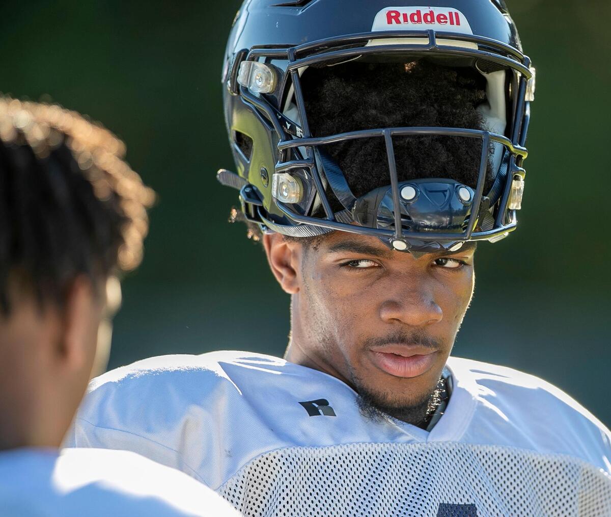 Millbrook High School wide receiver Nathan Leacock (1) talks with his teammates during their practice on Thursday, August, 31, 2022 in Raleigh, N.C.