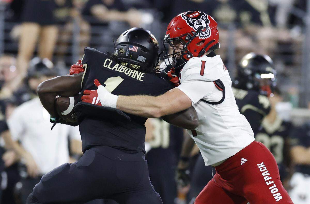 N.C. State linebacker Caden Fordham (1) wraps up Wake Forest running back Demond Claiborne (1) during the second half of N.C. State’s 34-24 victory over Wake Forest at Allegacy Stadium in Winston-Salem, N.C., Thursday, Sept. 11, 2025.