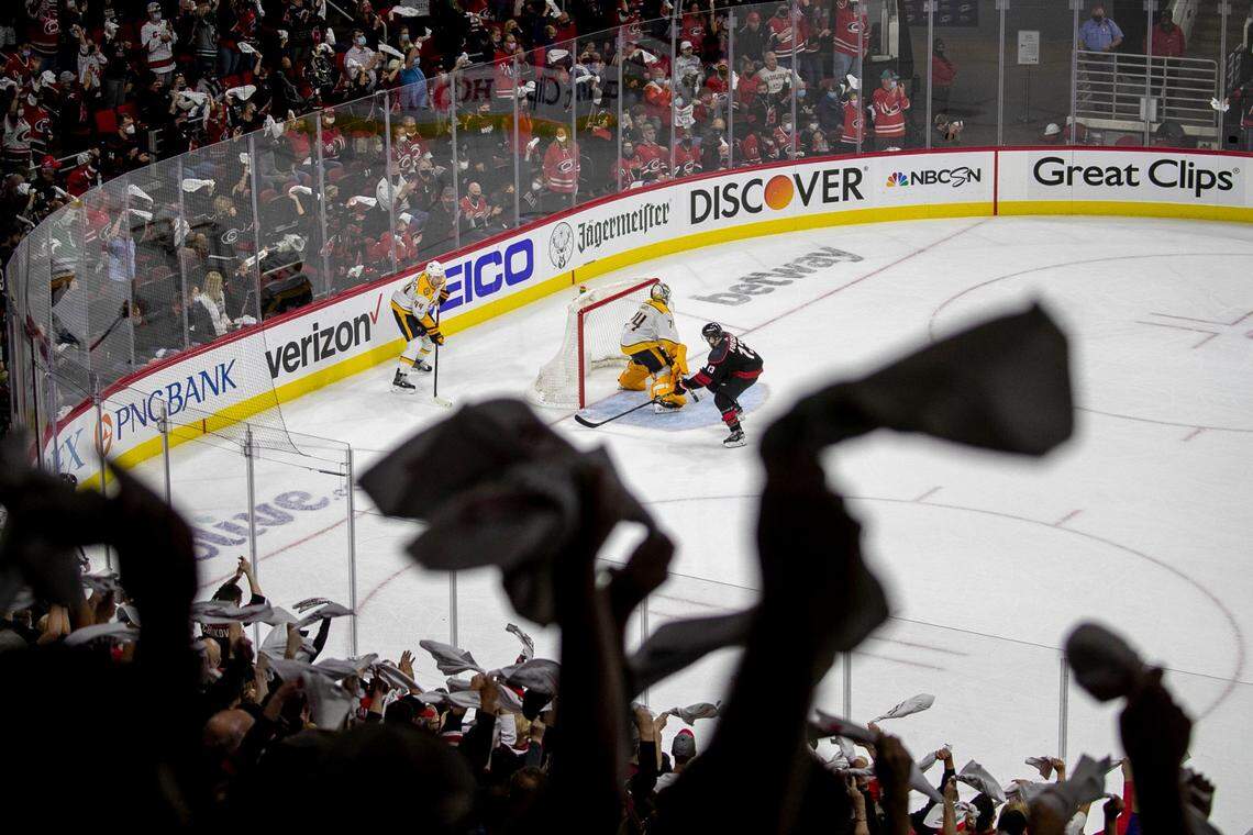 Fans wave their rally towels as the final seconds of the third period wind down, as the Hurricanes’ secure their 5-2 victory over Nashville in their first round Stanley Cup series game on Monday, May 17, 2021 at PNC Arena in Raleigh, N.C.